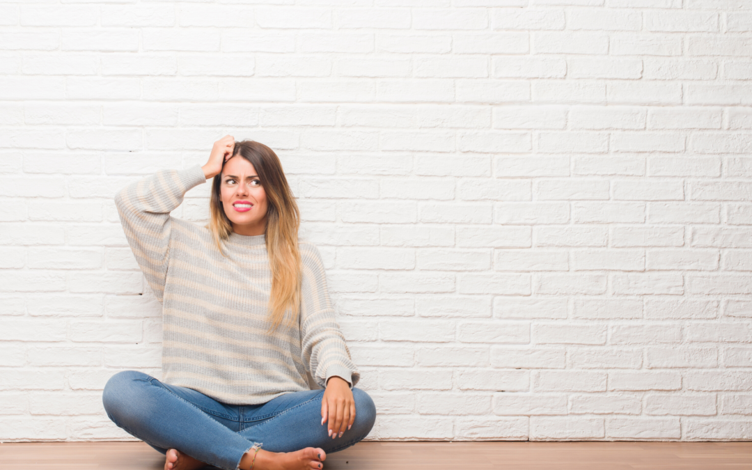 girl scratching her head with questions